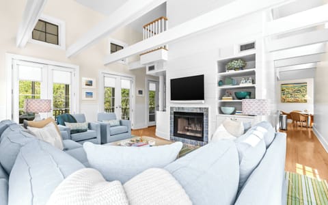 Your spacious living room welcomes you with soaring ceilings, a cozy fireplace, and plush seating. Natural light fills the open-concept space, creating the perfect spot to relax and enjoy your getaway.