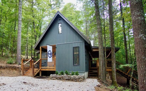 Camp Firefly! Modern luxury cabin tucked peacefully into the woods of Red River Gorge, featuring a spacious deck, hot tub, and cozy outdoor spaces designed for relaxing nature escapes.