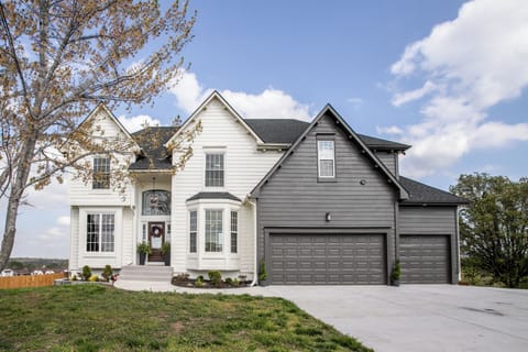 Modern exterior with upscale curb appeal and spacious driveway.