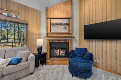 Sink into plush seating in your private living room, where a crackling fireplace and forest views create the perfect mountain retreat. Enjoy your favorite shows on the large TV after a day of adventure.