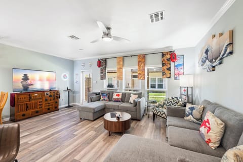 Sink into plush sofas and unwind in your spacious living room, where modern comforts meet Japanese artistic flair. Ceiling fans keep you cool as you gather for movie nights or lively conversation.