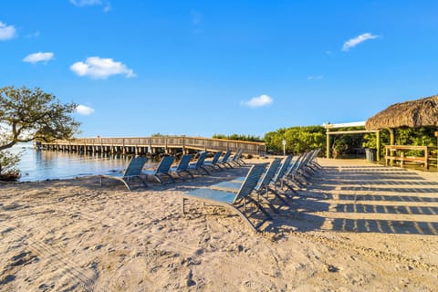 Lounge on soft sand steps from the calm water.