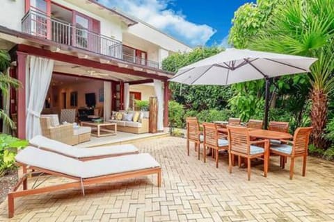 Pretty patio area with sun loungers, dining table to seat 8 guests and an enclosed garden.
