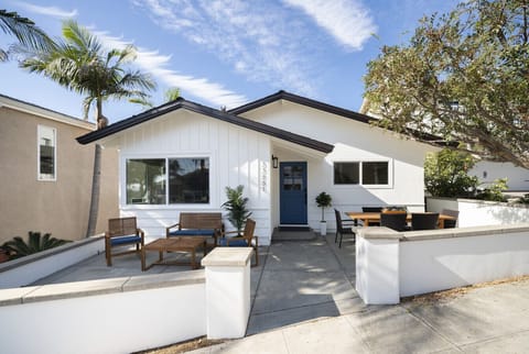 Modern Lantern District beach home with a welcoming front patio and outdoor dining area.