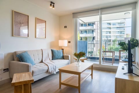 Bright and inviting living area with access to a private balcony, perfect for relaxing and enjoying city views.