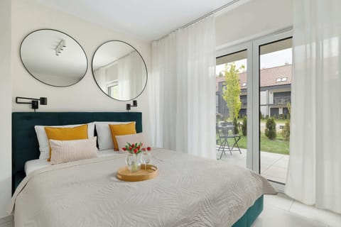 Bright studio apartment with a comfortable double bed, stylish décor, and large windows bringing in plenty of natural light.