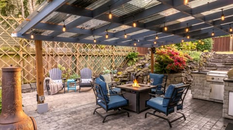 Outdoor Patio: Enjoy evenings by the fire, surrounded by lush gardens and twinkling lights!