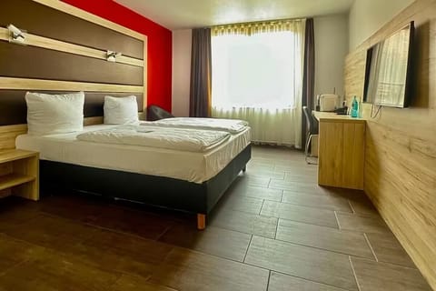 Unwind in a bright room with comfy beds and TV.