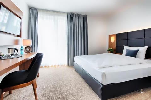 Unwind in a bright, modern room with plush bedding.