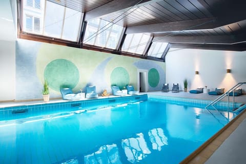 Dive into the sunlit indoor pool for instant relaxation.