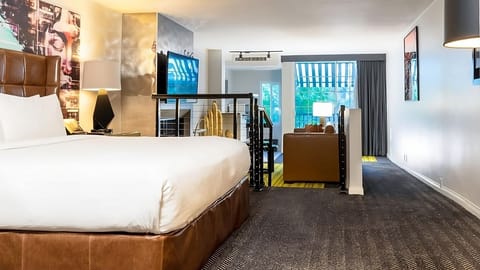 Unwind in a plush bed with open-plan lounge beyond.