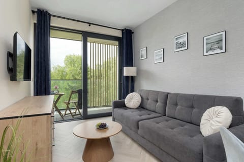Relax in the stylish living room with a comfortable sofa and modern decor.