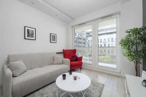 Bright living room with a comfortable sofa, stylish décor, and large windows bringing in plenty of natural light.