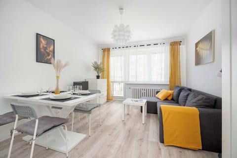 Bright living room with dining area and mustard accent