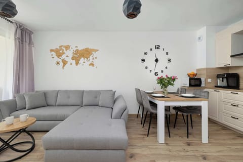 Bright living room with gray corner sofa and modern decor