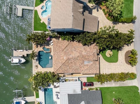 The Full Picture – From above, it's clear this waterfront retreat has it all — a sparkling private pool, lush tropical landscaping, and your very own boat dock steps from the water. Boat is not for guest use.