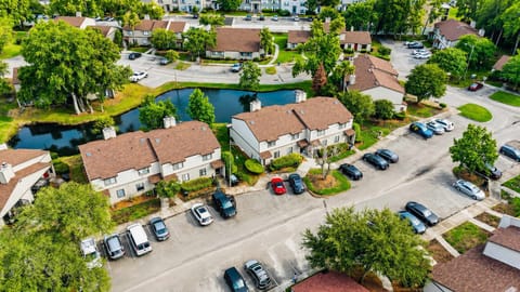 Exterior Oasis: Relax by the serene pond surrounded by lush greenery and charming architecture!