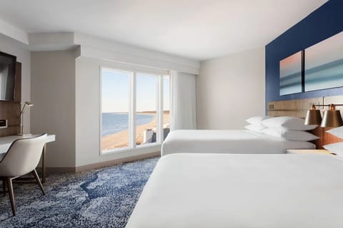 Stretch out in a spacious room framed by bright seaside light.