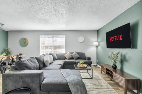 Spacious and inviting living area with comfortable seating and a smart TV, perfect for relaxing after exploring Arlington or attending events at AT&T Stadium.