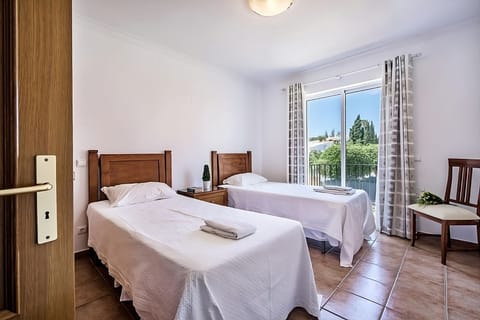 Drift off peacefully in twin beds beside a sunny window.