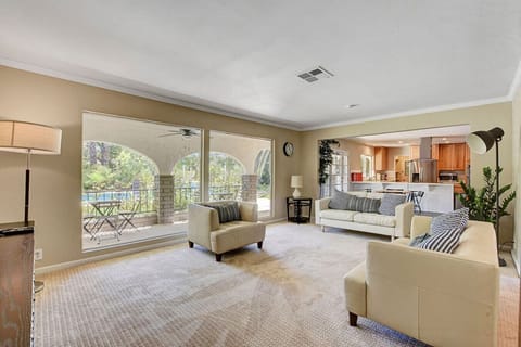 Open-concept living room with natural light and yard views