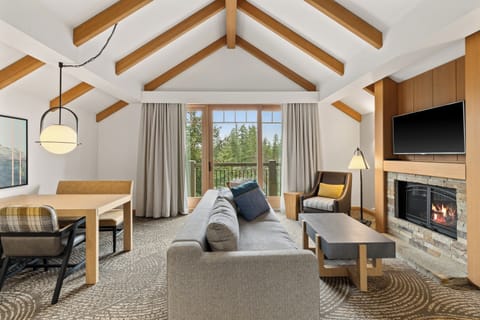 Relax after a day of exploring in the spacious lounge complete with comfortable seating, warm wood accents, and stunning outdoor views.
