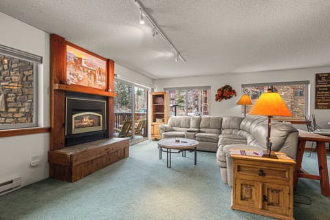 Sink into plush seating by the warm glow of your private fireplace, where mountain views frame your perfect retreat after a day of adventure.
