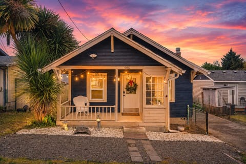 Charming bungalow with cozy porch and glowing sunset curb appeal
