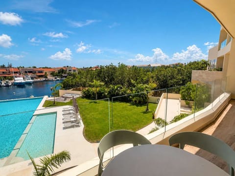 Private terrace with direct views of the pool and marina canal.