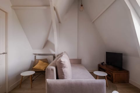 The living area offers comfortable seating in a bright and open setting.