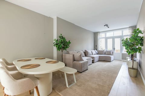 Bright living room with large sofa and natural light, perfect for relaxing after exploring the city.