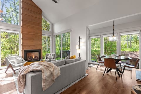 Cozy mountain ski condo featuring beautiful aspen and creek views, a warm fireplace, and an open living area that extends to the loft above. The perfect retreat to relax after a day on the slopes, surrounded by nature and mountain charm.