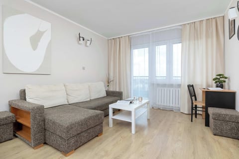 Bright studio bedroom with sofa bed and balcony access