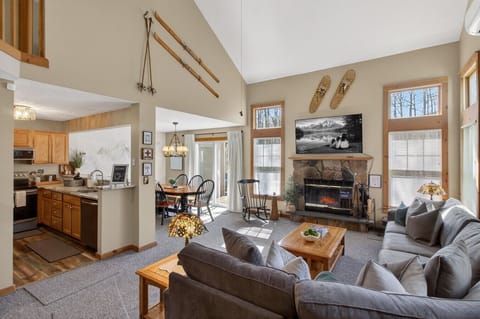 ✨ Gather, relax, and cozy up by the stone fireplace in this bright mountain retreat.