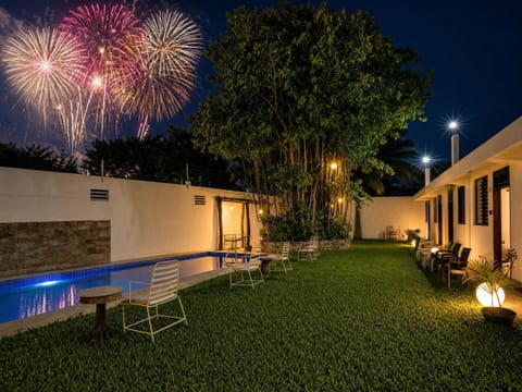 Private poolside lawn with ambient lighting and stunning fireworks views