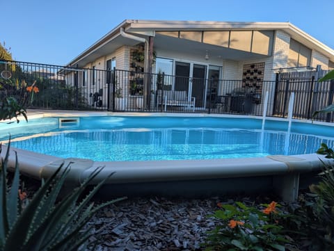 Private fenced pool with covered patio for easy outdoor living