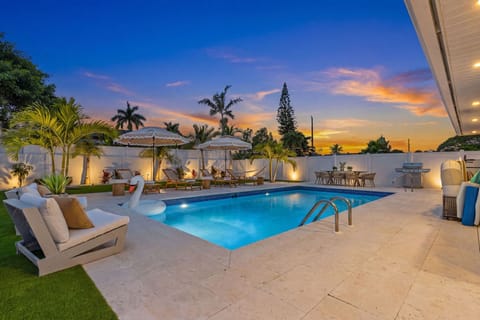 Private heated pool, tropical landscaping, and resort-style outdoor living perfect for relaxing after a day at the beach
