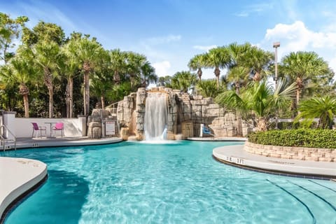 Dive into a tropical pool beneath a cascading waterfall.