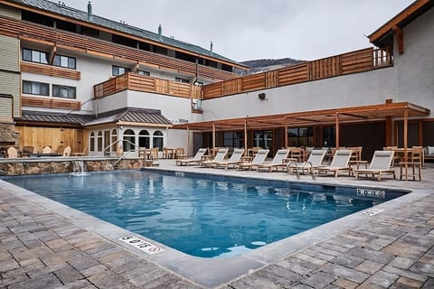 Linger poolside under covered seating for relaxed afternoon breaks.