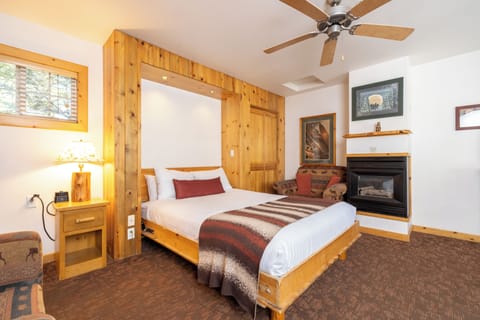 Unwind in a cozy bed beside the warm, crackling fireplace.