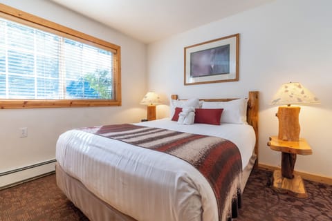 Sink into a welcoming bed with warm, rustic charm.