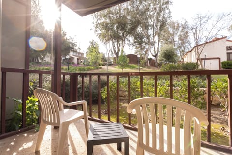 Sip morning coffee on the balcony overlooking peaceful greenery.