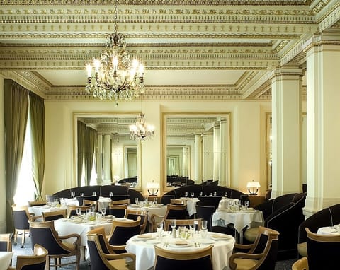 Savor elegant dining beneath chandeliers in timeless style.