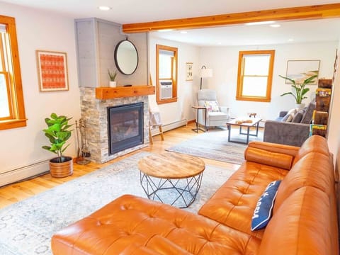Large living room with comfortable leather couch, sofa bed and recliner chair.