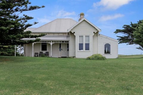 Exterior with spacious lawn and coastal charm.