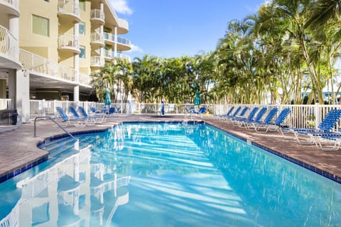 Dive into refreshing waters, with inviting loungers patiently waiting for you.