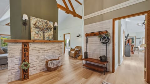Welcoming foyer space featuring a convenient clothes rack, perfect for hanging jackets, coats, and bags as you settle in. 