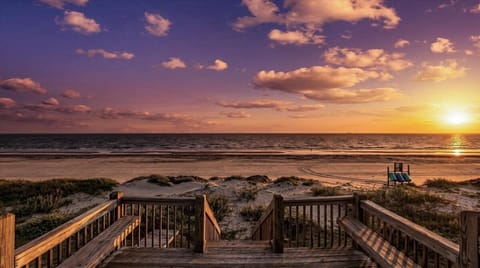 Stunning beachfront sunrise view with private beach access in Port Bolivar, TX. Peaceful Gulf Coast scenery with sandy dunes and direct path to Crystal Beach.
