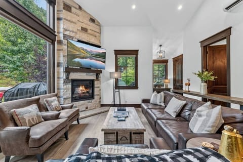 Living room with fireplace, Smart TV and tons of natural light