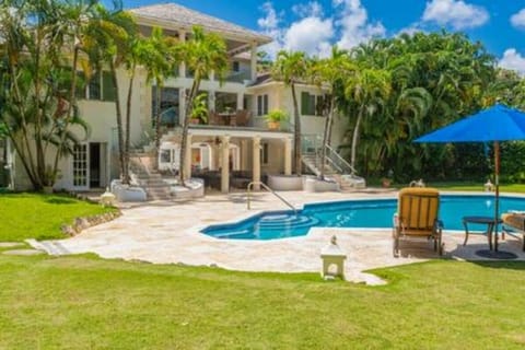 Private swimming pool with ample sun beds and parasols situated within the well manicured private gardens.